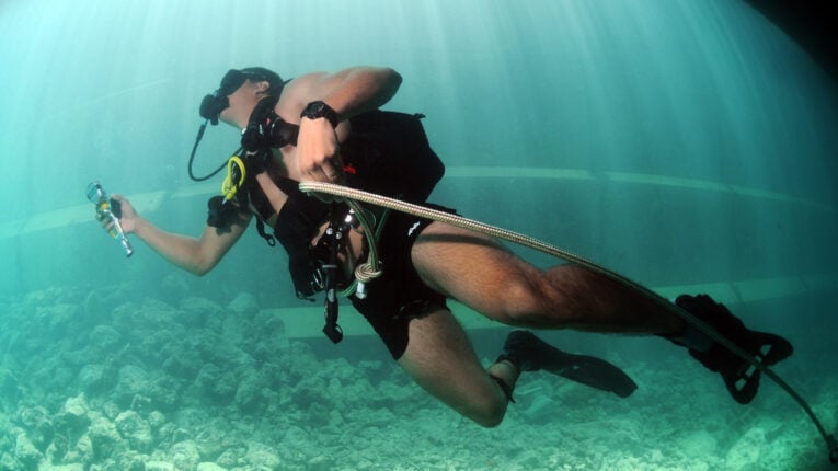 Navy Diver placing training mine while wearing G-Shock DW6600