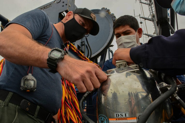 Navy diver wearing G-Shock GD350 while observing deep dive drills