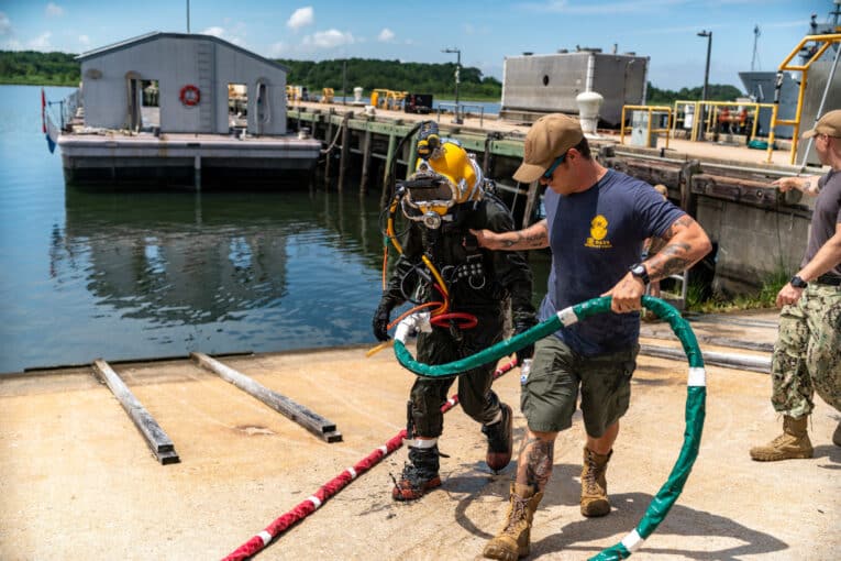 Navy diver tending diver while wearing G-Shock DW6900