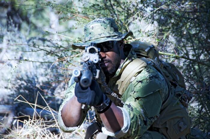 Woodland camouflage-outfitted Navy SEAL wearing a G-Shock watch military-style